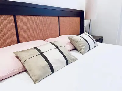 a bedroom with a bed with two pillows on it at Planta baja en pleno centro de la playa in Moncófar