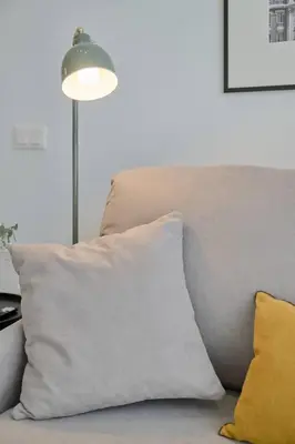 a white pillow sitting on a couch with a lamp at Romantic Suite Roig Arena N4 Virkin Suites in Valencia