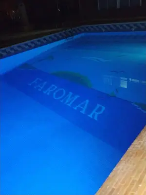 a blue swimming pool with the word melatonin on it at Cullera Playa de los Olivos Apartment in Faro de Cullera