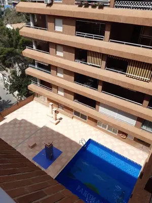 an overhead view of a building with a swimming pool at Cullera Playa de los Olivos Apartment in Faro de Cullera