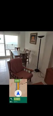 a living room with a table and a chair at Apartamento primera línea Cullera in Cullera