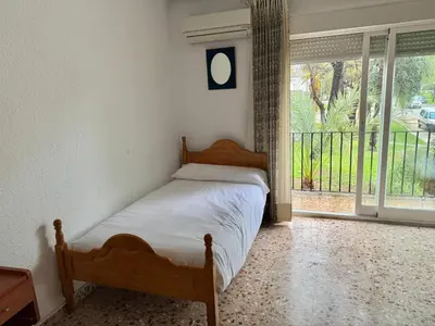 a bedroom with a large bed and a window at La casa del señorito in Tous