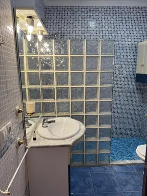 a small bedroom with a bed and a table at La casa del señorito in Tous