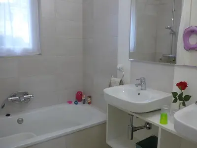 a white bathroom with a sink and a bath tub and a sink at Casa Kiosko 1 bedroom ground floor with swimming pool in La Eliana
