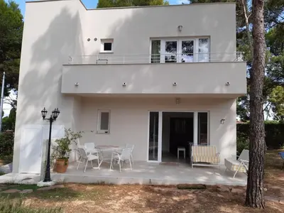 a white house with a table and chairs at Casa Kiosko 1 bedroom ground floor with swimming pool in La Eliana