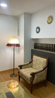 a living room with a chair and a lamp at Hostal Casa Sifre in Villanueva de Castellón