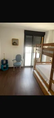 a bedroom with a bunk bed and a chair at Hostal Casa Sifre in Villanueva de Castellón