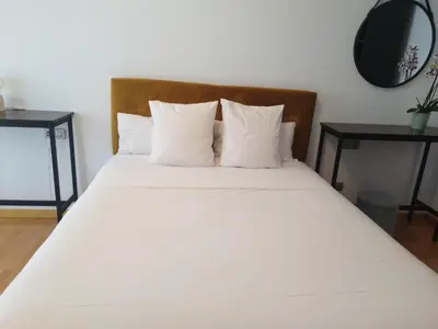 a bed with white sheets and pillows in a room at magníficas vistas in Valencia