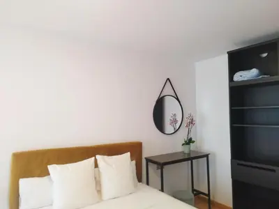 a bedroom with a bed with a mirror and a table at magníficas vistas in Valencia