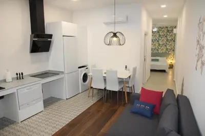 a kitchen and living room with a couch and a table at A Malilla&Ruzafa in Valencia