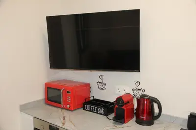 a microwave sitting on top of a counter with a tv at A Malilla&Ruzafa in Valencia