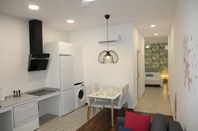 a kitchen and living room with a couch and a table at A Malilla&Ruzafa in Valencia