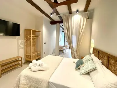a bedroom with a bed with towels on it at Pepitos House in Valencia