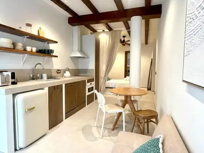 a kitchen with a table and a dining room at Pepitos House in Valencia