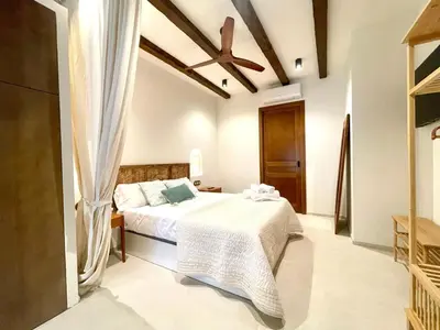 a bedroom with a bed and a ceiling fan at Pepitos House in Valencia