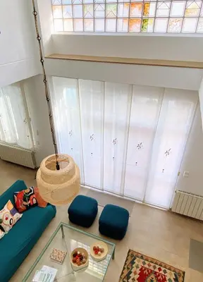a living room with a blue couch and a window at Domus Belle Home Valencia in Foyos