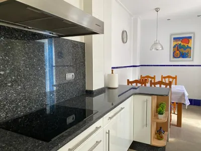 a kitchen with black granite counter tops and a dining room at Domus Belle Home Valencia in Foyos