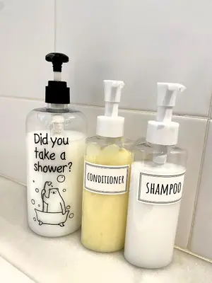 three bottles of detergents sitting on a bathroom counter at Domus Belle Home Valencia in Foyos