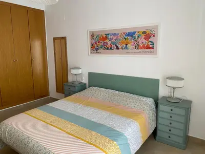 a bedroom with a bed with two night stands and two lamps at Domus Belle Home Valencia in Foyos