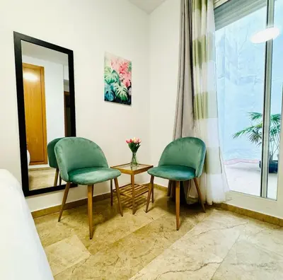 two chairs and a table in a room with a window at ABAT 1 Cool & Wide Flat next to the Cathedral in Valencia
