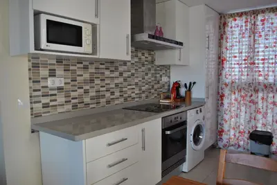 a kitchen with a sink and a stove top oven at RelaxUp Apartment Patacona Beach in Valencia