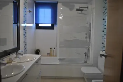 a bathroom with two sinks and a shower and a toilet at RelaxUp Apartment Patacona Beach in Valencia