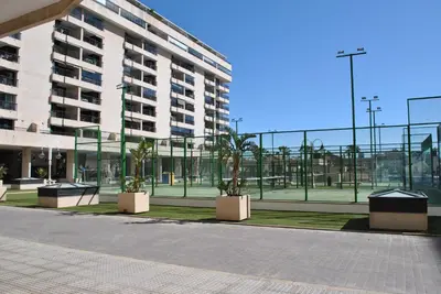 a building with palm trees in front of a building at RelaxUp Apartment Patacona Beach in Valencia