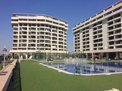 two tall buildings with a pool in front of a building at RelaxUp Apartment Patacona Beach in Valencia