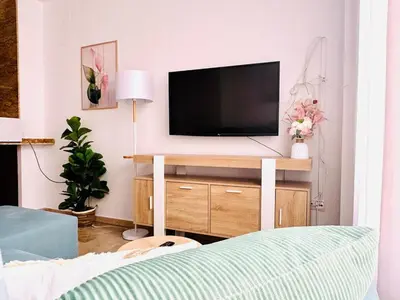 a living room with a flat screen tv on a cabinet at ABAT 2 Cool & Wide Flat next to the Cathedral in Valencia