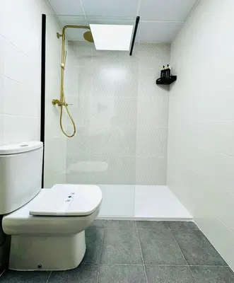a bathroom with a toilet and a glass shower at ABAT 2 Cool & Wide Flat next to the Cathedral in Valencia