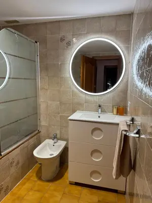 a bathroom with a sink and a toilet and a mirror at Puebla de Farnals playa- Oasis Apartments - Costa de Valencia Beachside Stay in Puebla de Farnals