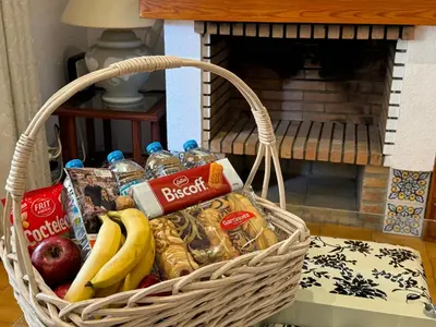 a basket filled with food and snacks in front of a fireplace at Puebla de Farnals playa- Oasis Apartments - Costa de Valencia Beachside Stay in Puebla de Farnals