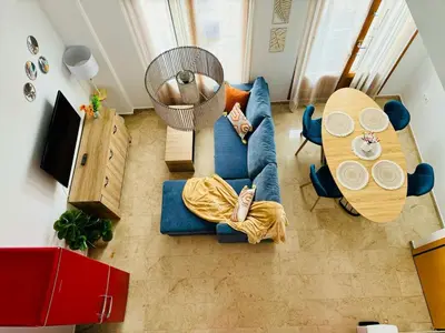 a living room with a blue couch and a table at ABAT 3 Cool & Wide Duplex Next to the Cathedral in Valencia