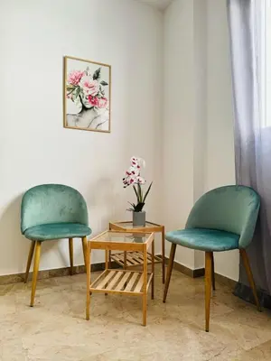 two chairs and a table with a vase of flowers at ABAT 3 Cool & Wide Duplex Next to the Cathedral in Valencia