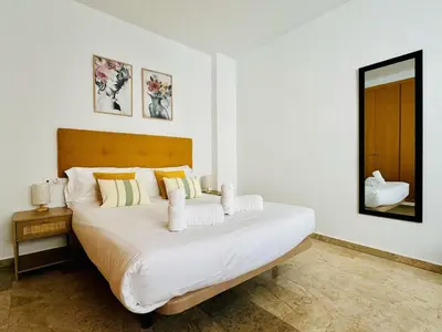 a bedroom with a large white bed with a mirror at ABAT 3 Cool & Wide Duplex Next to the Cathedral in Valencia