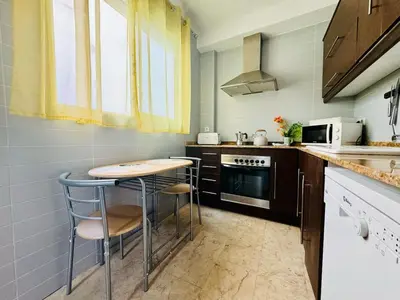 a kitchen with a table and two stools at ABAT 4 Cool & Wide Studio in the Historic Center in Valencia