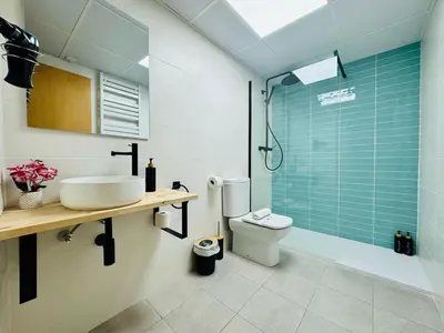a bathroom with a toilet and a sink and a shower at ABAT 4 Cool & Wide Studio in the Historic Center in Valencia