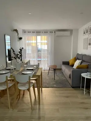 a living room with a table and a couch at Where You Feel Home in Godella