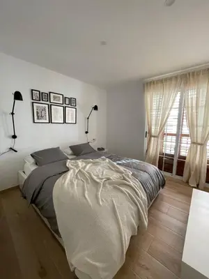 a white bedroom with a large bed and a window at Where You Feel Home in Godella