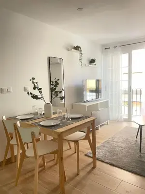 a dining room with a table and chairs and a mirror at Where You Feel Home in Godella