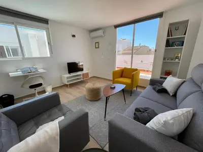 a living room with two couches and a television at More then a bright studio in Godella