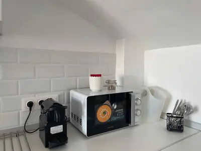 a microwave sitting on top of a kitchen counter at More then a bright studio in Godella