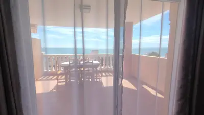 a balcony with a table and a view of the ocean at Playa Paradis III - Primera linea de playa in Moncófar
