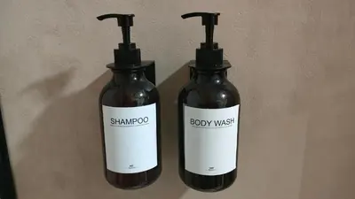 two bottles of sambro soap mix sitting on a wall at Playa Paradis III - Primera linea de playa in Moncófar