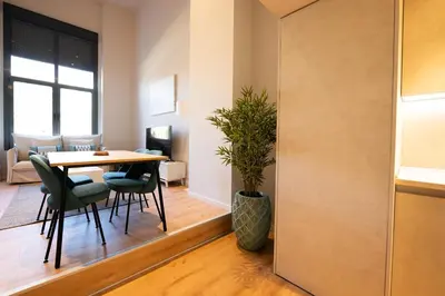 a dining room and living room with a table and chairs at City of Arts Valencia Flats by Rent Me in Valencia