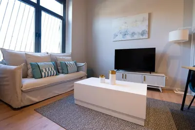 a living room with a couch and a flat screen tv at City of Arts Valencia Flats by Rent Me in Valencia