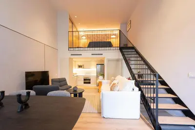 an open living room with a staircase and a living room at City of Arts Valencia Flats by Rent Me in Valencia