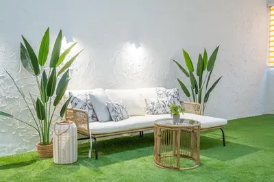 a white couch sitting in a room with plants at Flats poeta serrano in Valencia