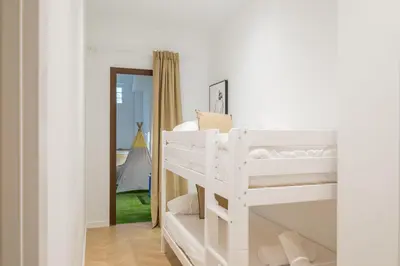a white bunk bed in a room with a mirror at Flats poeta serrano in Valencia