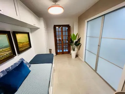 a living room with a couch and a table at Port Saplaya little Venice 10 days minimum in Port Saplaya